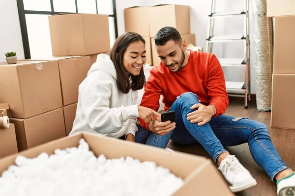 Young Latin Couple Smiling Happy Using Smartphone New Home — Stock Photo, Image
