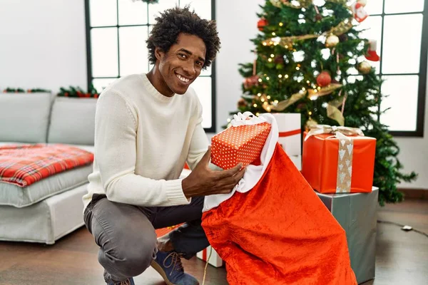 Young African American Man Holding Gifts Santa Claus Bag Home — Stock Photo, Image