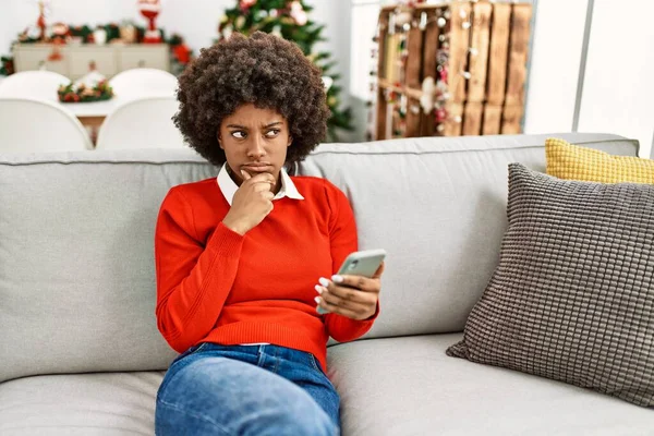 Νεαρή Αφροαμερικανίδα Γυναίκα Αφρο Μαλλιά Χρησιμοποιώντας Smartphone Κάθεται Στον Καναπέ — Φωτογραφία Αρχείου