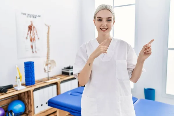 Mulher Branca Jovem Trabalhando Clínica Recuperação Dor Sorrindo Olhando Para — Fotografia de Stock