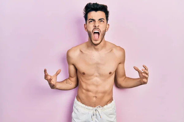 Young Hispanic Man Wearing Swimwear Shirtless Crazy Mad Shouting Yelling — Stock Photo, Image
