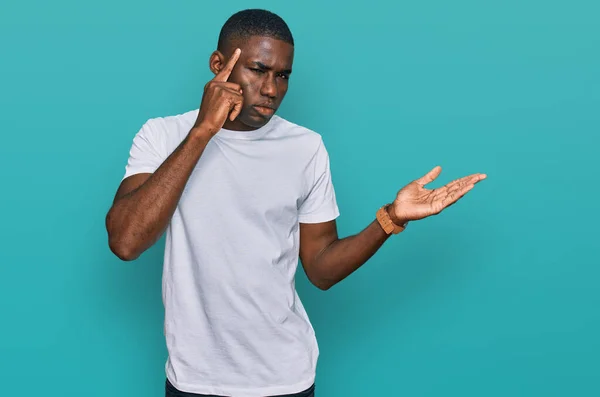 Jovem Afro Americano Vestindo Camiseta Branca Casual Confusa Irritada Com — Fotografia de Stock