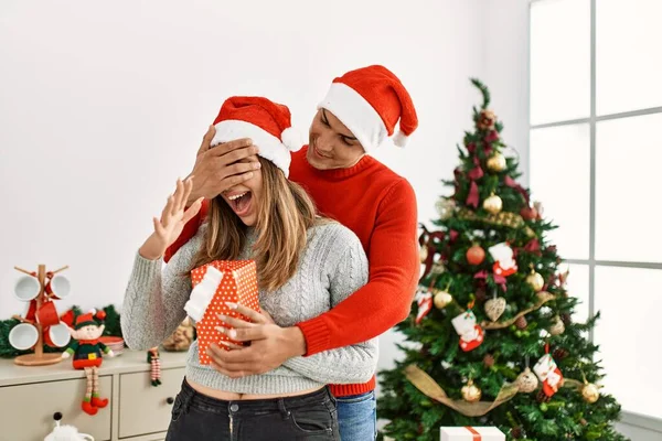 Young Couple Hugging Smiling Happy Man Surprising Woman Gift Home — Stock Photo, Image