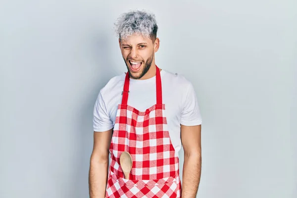 Young Hispanic Man Modern Dyed Hair Wearing Apron Winking Looking — Stock Photo, Image