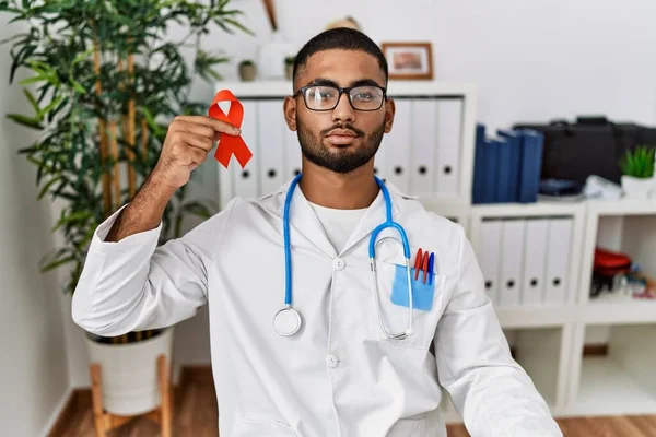 Young Indian Doctor Holding Support Red Ribbon Thinking Attitude Sober — Stock Photo, Image