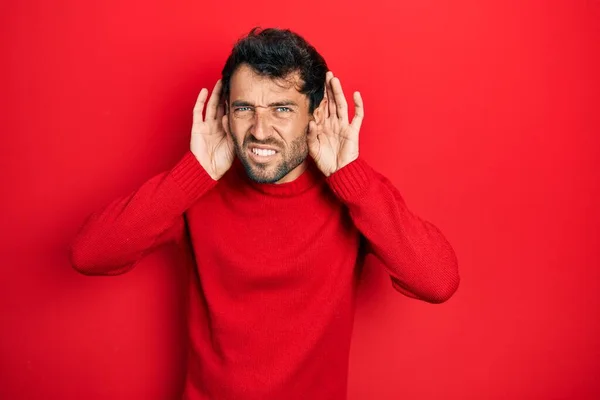 Handsome Man Beard Wearing Casual Red Sweater Trying Hear Both — Stock Photo, Image