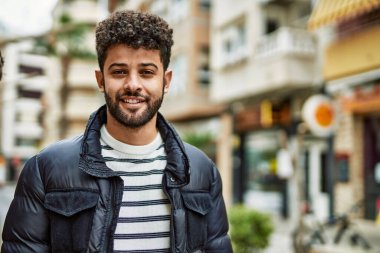 Kasabada gülümseyen genç bir Arap.