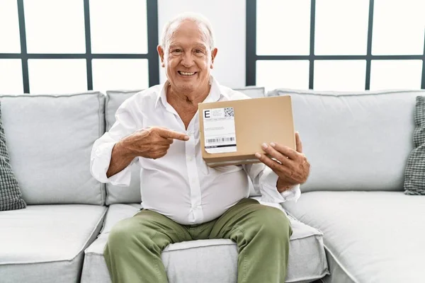 Senior Man Holding Delivery Package Home Smiling Happy Pointing Hand — Stock fotografie