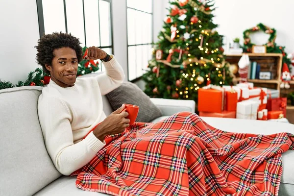 Young African American Man Sitting Sofa Drinking Coffee Christmas Tree — Stock Photo, Image
