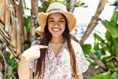 Genç esmer kadın yazın güneşli bir gününde gururla bağırıyor zaferi ve başarıyı kutluyor. Kollarını kaldırıp heyecanla bekliyor. 