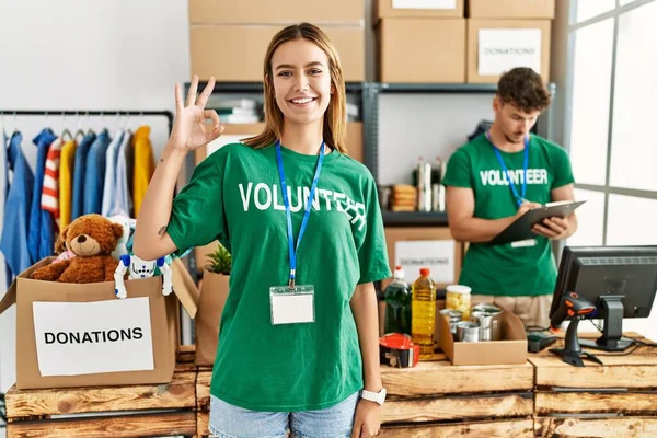 Young Blonde Girl Wearing Volunteer Shirt Donation Stand Smiling Positive — Fotografia de Stock