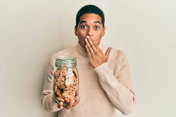 Joven Hombre Hispano Guapo Sosteniendo Tarro Galletas Chispas Chocolate Cubriendo — Foto de Stock