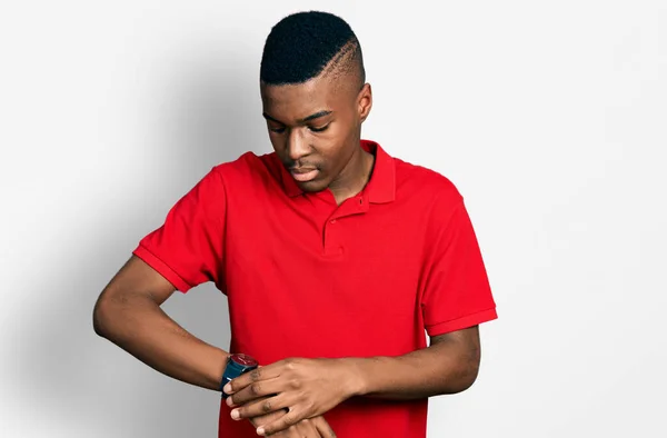 Young African American Man Wearing Casual Red Shirt Checking Time — Stock Photo, Image