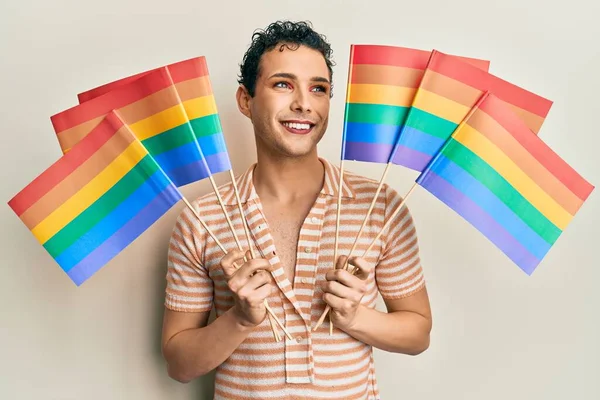 Hombre Guapo Usando Maquillaje Sosteniendo Banderas Arco Iris Lgbtq Sonriendo —  Fotos de Stock