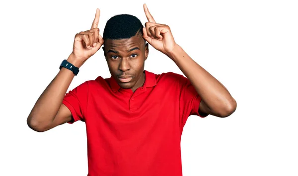 Genç Afrikalı Amerikalı Sıradan Kırmızı Tişörtler Giyen Parmağıyla Boynuz Gibi — Stok fotoğraf