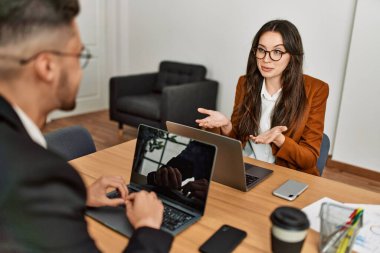 Ofiste çalışırken gülümseyen iki İspanyol iş adamı..