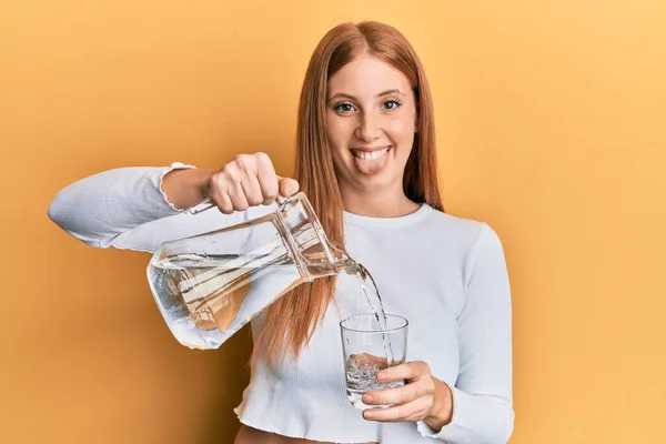 Young Irish Woman Pouring Water Sticking Tongue Out Happy Funny — Stock Photo, Image