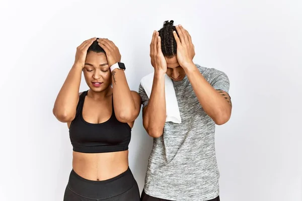 Young Latin Couple Wearing Sportswear Standing Isolated Background Suffering Headache — Stok fotoğraf