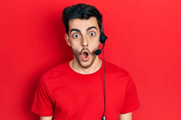 Young Hispanic Man Wearing Call Center Agent Headset Scared Amazed — Stock Photo, Image