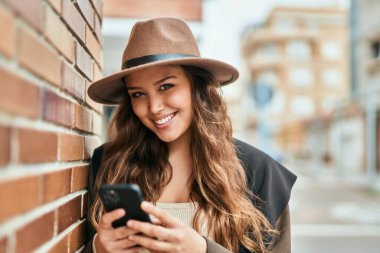 Şehirde akıllı telefon kullanan genç İspanyol turist kadın..