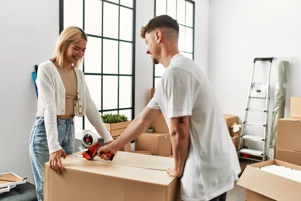 Young Caucasian Couple Smiling Happy Closing Box Using Packing Tape — Stock Photo, Image