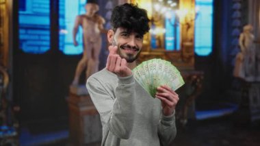 Man holding russian ruble banknotes indoors at museum with a confident smile, showcasing wealth and elegance.