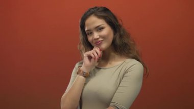 Genç cazibesi ve kendine güveni olan stüdyo ışıkları altında özgüvenle poz veren bir kadın..