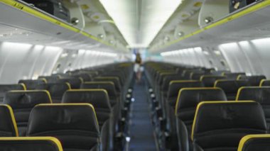 Uçak kabin sıraları deri koltuklar ve üst kutular yumuşak bulanık bokeh koridor çözünmüş iç; arka plan arka plan telif alanı şablonu.