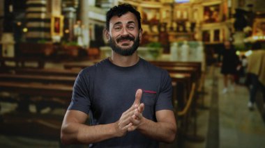 Sakallı İspanyol bir adam güzel aydınlatılmış bir Katolik kilisesinde el çırpıyor, sıcaklığı ve kültürel zenginliği ince detaylarıyla aktarıyor..