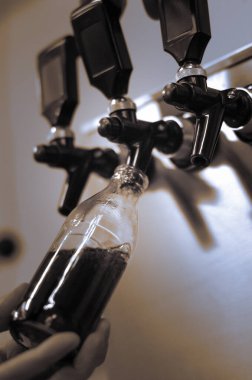 manual filling of a small bottle