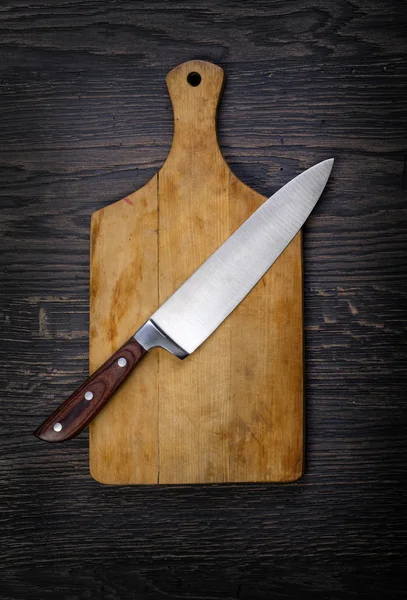 Empty chopping board with a knife — Stock Photo, Image