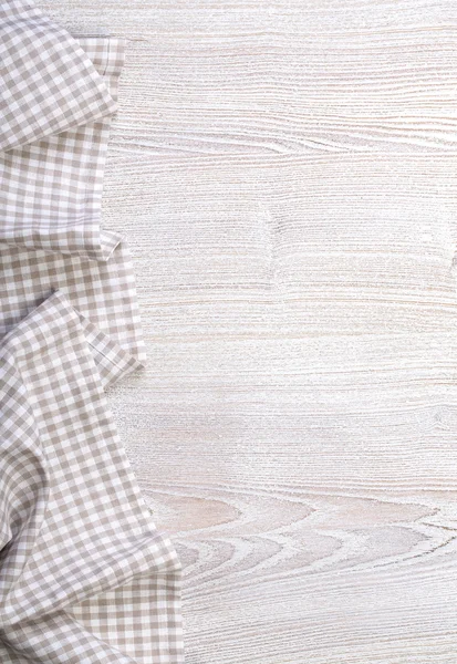 Checkered tablecloth on wooden — Stock Photo, Image