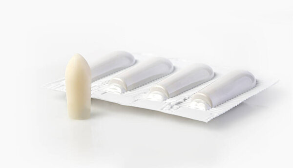 Suppository for anal or vaginal use on a white background. Candles for treatment of hemorrhoids, temperature, thrush, inflammation