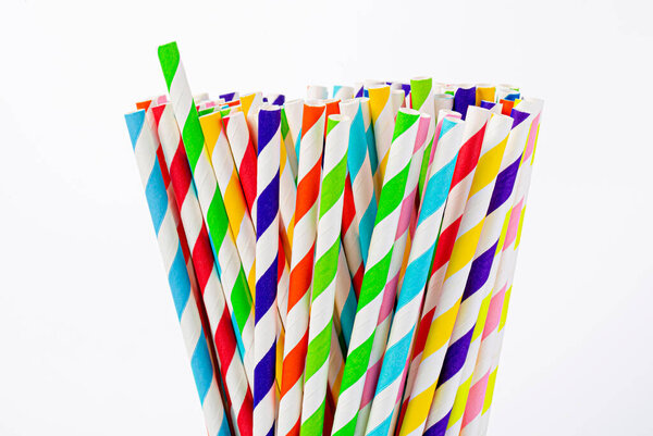 Paper straw of different colors on a white background with a copy space