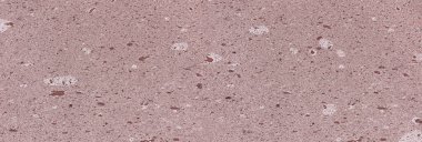 Porous mauve speckled rock creating natural stone textured background