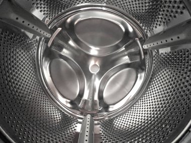 Clean stainless steel drum interior of a modern washing machine with perforated surface