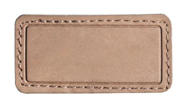 Dikdörtgen kahverengi deri yama ve dikişli kenar. Şeffaf bir arkaplan üzerinde izole edilmiş boş bir etiket alanı yaratıyor.