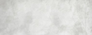 Kaba doku ve minimalist desen gösteren gri beton duvar