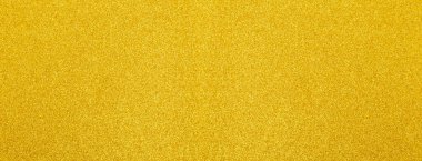 Soyut lüks dekoratif arkaplan için parlak parlak bir dokuyu gösteren altın parıltı malzemesi