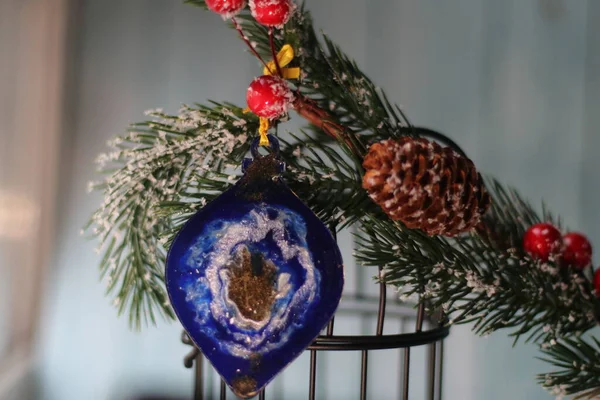 Christmas tree branch with cones and Christmas toy — Stock Photo, Image