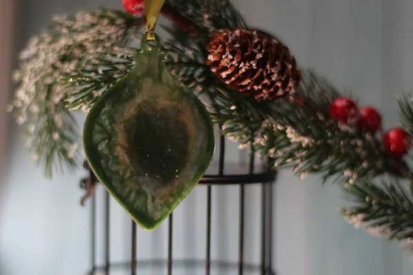 Christmas tree branch with cones and Christmas toy — Stock Photo, Image