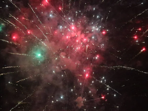 Multicolored new year fireworks in the dark sky — Stock Photo, Image
