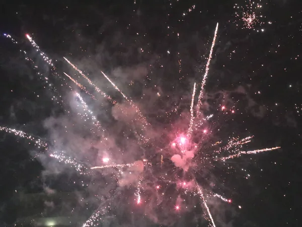 Multicolored new year fireworks in the dark sky — Stock Photo, Image