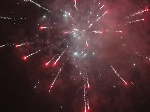 Multicolored new year fireworks in the dark sky — Stock Photo, Image