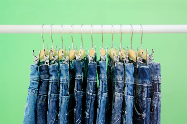 Row of hanged blue jeans — Stock Photo, Image