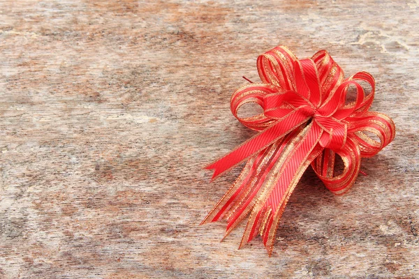 Red Ribbon on Old Wood Background — Stock Photo, Image