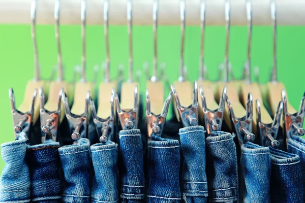 Row of hanged blue jeans — Stock Photo, Image