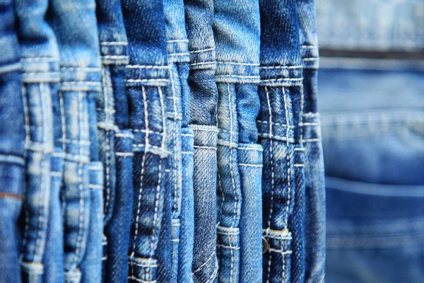 Row of hanged blue jeans — Stock Photo, Image