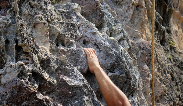 Hand fixing on stone rock — Stock Photo, Image