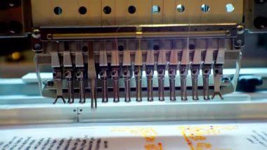 Tekstil endüstrisi. Modern endüstriyel nakış makinesi kumaşa şablon uyguluyor..